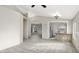 Inviting living room with neutral tones, tile floors, and a breakfast bar that opens to the kitchen at 26 S Tiago Dr, Gilbert, AZ 85233