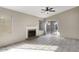 Spacious living room with fireplace, sliding glass door, and tile flooring at 26 S Tiago Dr, Gilbert, AZ 85233