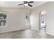 Bright main bedroom featuring wood-look floors, a ceiling fan, and an archway leading to the bathroom at 26 S Tiago Dr, Gilbert, AZ 85233