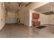 Spacious garage featuring epoxy floors, storage cabinets, and ample room for vehicles at 26693 N 82Nd Dr, Peoria, AZ 85383