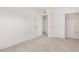 Empty bedroom features fresh paint, tile flooring, and ample closet space at 2944 W Royal Palm Rd, Phoenix, AZ 85051