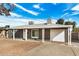 Charming single-story home with grey exterior, covered porch, and low-maintenance desert landscaping at 2944 W Royal Palm Rd, Phoenix, AZ 85051