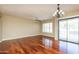 Bright living room with hardwood floors, ceiling fan, and sliding doors to the outside patio at 2989 N 44Th St # 2007, Phoenix, AZ 85018