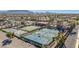 This aerial view shows community tennis and basketball courts amid well-maintained landscaping, near neighborhood homes at 3401 E Isaiah Ave, Gilbert, AZ 85298