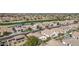 This aerial view showcases a community with a golf course, lake, and well-maintained landscaping between the homes at 3401 E Isaiah Ave, Gilbert, AZ 85298