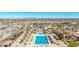This aerial view showcases a community pool, water slides, and recreational amenities with a mountain backdrop at 3401 E Isaiah Ave, Gilbert, AZ 85298