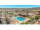 Aerial view of community amenities, including a large pool, palm trees, and recreational facilities against a mountain backdrop at 3401 E Isaiah Ave, Gilbert, AZ 85298