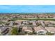 Aerial view of a neighborhood with tile roofs and landscaping, next to golf course at 3401 E Isaiah Ave, Gilbert, AZ 85298