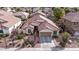 Aerial view of a home with tile roof, desert landscaping, and front-facing garage at 3401 E Isaiah Ave, Gilbert, AZ 85298