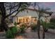Charming backyard featuring covered patio with string lights and lush landscaping at 3401 E Isaiah Ave, Gilbert, AZ 85298