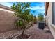 A/C unit in landscaped backyard with rock ground cover and small tree at 3401 E Isaiah Ave, Gilbert, AZ 85298