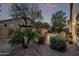 Beautifully landscaped backyard with a fountain, seating area, and desert plants at 3401 E Isaiah Ave, Gilbert, AZ 85298