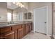 Bathroom with double sinks, granite countertops, and a large mirror at 3401 E Isaiah Ave, Gilbert, AZ 85298