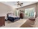 Inviting bedroom with tile flooring, a ceiling fan, and plenty of natural light at 3401 E Isaiah Ave, Gilbert, AZ 85298