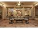 Relaxing covered patio featuring comfortable seating and views into the home's interior at 3401 E Isaiah Ave, Gilbert, AZ 85298