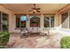 Comfortable covered patio with plush seating and an outdoor ceiling fan for hot days at 3401 E Isaiah Ave, Gilbert, AZ 85298
