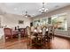 Open concept dining area showcasing hardwood floors, a large table set, and views of the backyard at 3401 E Isaiah Ave, Gilbert, AZ 85298