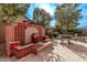 Outdoor fountain with decorative tiling and lush landscaping, creating a peaceful backyard retreat at 3401 E Isaiah Ave, Gilbert, AZ 85298