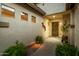 Charming front entrance with a brick pathway, decorative plants, and a warm, inviting ambiance with accent lighting at 3401 E Isaiah Ave, Gilbert, AZ 85298