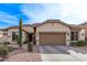 Charming home showcasing desert landscaping and a neutral-toned exterior with a spacious two-car garage at 3401 E Isaiah Ave, Gilbert, AZ 85298