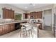 Kitchen with granite countertops, stainless steel appliances, tiled backsplash and island with seating at 3401 E Isaiah Ave, Gilbert, AZ 85298