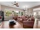 Bright living area showcasing hardwood floors, large windows, and a comfortable seating arrangement with views of the backyard at 3401 E Isaiah Ave, Gilbert, AZ 85298
