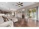 Spacious living room features a large sofa, wood floors, and sliding glass doors to the outside at 3401 E Isaiah Ave, Gilbert, AZ 85298