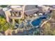 Aerial view highlighting the home's outdoor oasis with a pool, lounge area, and lush desert landscape at 34460 N 79Th Way, Scottsdale, AZ 85266