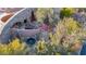 Bird's eye view of a desert home showcasing unique architecture, a courtyard, water features, and lush desert landscaping at 34460 N 79Th Way, Scottsdale, AZ 85266