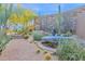 Desert backyard featuring native plants, a stone fountain, and a beautiful rock wall creating a serene outdoor space at 34460 N 79Th Way, Scottsdale, AZ 85266