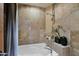 Elegant bathroom featuring a soaking tub with stylish tile surround and modern fixtures at 34460 N 79Th Way, Scottsdale, AZ 85266