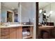 Bathroom vanity featuring granite countertops, ample storage, and a decorative mirror at 34460 N 79Th Way, Scottsdale, AZ 85266