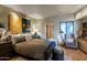 Spacious bedroom featuring a large bed, unique artwork, and access to outdoor views at 34460 N 79Th Way, Scottsdale, AZ 85266