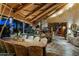 Elegant dining room featuring exposed-beam vaulted ceilings, stone floors, and a stone fireplace at 34460 N 79Th Way, Scottsdale, AZ 85266