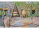Desert home entrance with unique stone design, native plants, and a statement front door creating an inviting curb appeal at 34460 N 79Th Way, Scottsdale, AZ 85266