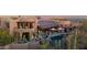 Desert home exterior featuring balconies, a pool, outdoor seating, and stunning desert landscape at 34460 N 79Th Way, Scottsdale, AZ 85266