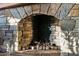 This stone fireplace offers warmth and rustic charm at 34460 N 79Th Way, Scottsdale, AZ 85266