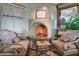 Fireplace with uniquely styled chairs and views to the exterior at 34460 N 79Th Way, Scottsdale, AZ 85266