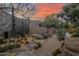 Landscaped front yard featuring mature cacti, succulents, and stone elements enhance this desert property at sunset at 34460 N 79Th Way, Scottsdale, AZ 85266
