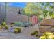 Desert landscaped front yard with mature cacti and succulents, alongside stone accents enhances this property at 34460 N 79Th Way, Scottsdale, AZ 85266
