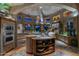 Gourmet kitchen featuring stone countertops, custom cabinetry, and modern lighting at 34460 N 79Th Way, Scottsdale, AZ 85266