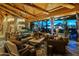 Bright living room featuring exposed-beam ceilings, stone floors, generous seating, and views of the outdoor living space at 34460 N 79Th Way, Scottsdale, AZ 85266