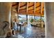 Spacious living room featuring a dining area, flagstone floors, wood ceilings, and floor to ceiling windows at 34460 N 79Th Way, Scottsdale, AZ 85266