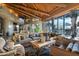 Comfortable living room with stone floors, exposed-beam ceilings, a generous seating area, and an inviting fireplace at 34460 N 79Th Way, Scottsdale, AZ 85266