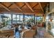 Bright living room boasts a stone fireplace, exposed-beam ceilings, a bar, and views of Arizona landscape at 34460 N 79Th Way, Scottsdale, AZ 85266