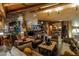 Cozy living room boasts a stone fireplace, exposed-beam ceilings, and unique stone floors at 34460 N 79Th Way, Scottsdale, AZ 85266