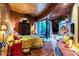 Comfortable main bedroom featuring a cozy fireplace and private patio access at 34460 N 79Th Way, Scottsdale, AZ 85266