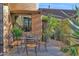 Outdoor patio with dining set surrounded by lush greenery and desert landscaping at 34460 N 79Th Way, Scottsdale, AZ 85266