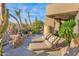 Outdoor patio with lounge chairs, desert landscaping, and luxurious desert home at 34460 N 79Th Way, Scottsdale, AZ 85266