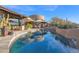 A luxurious outdoor pool with lounge chairs, landscaping, and a modern home exterior under a clear blue sky at 34460 N 79Th Way, Scottsdale, AZ 85266